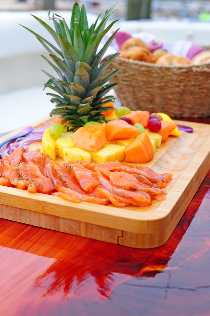 Salmon and fruit platter with pineapple centerpiece.
