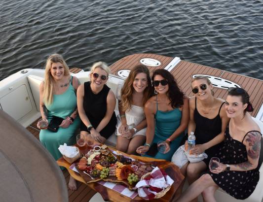 A Group Having Dinner While on a Sunset Cruise